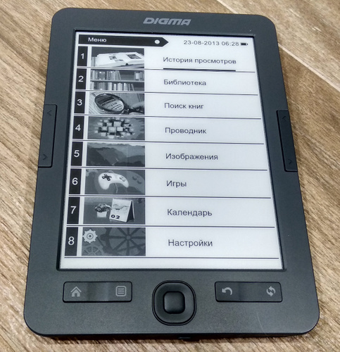 Электронная книга Digma K1 для настоящих книголюбов лежит на деревянном столе